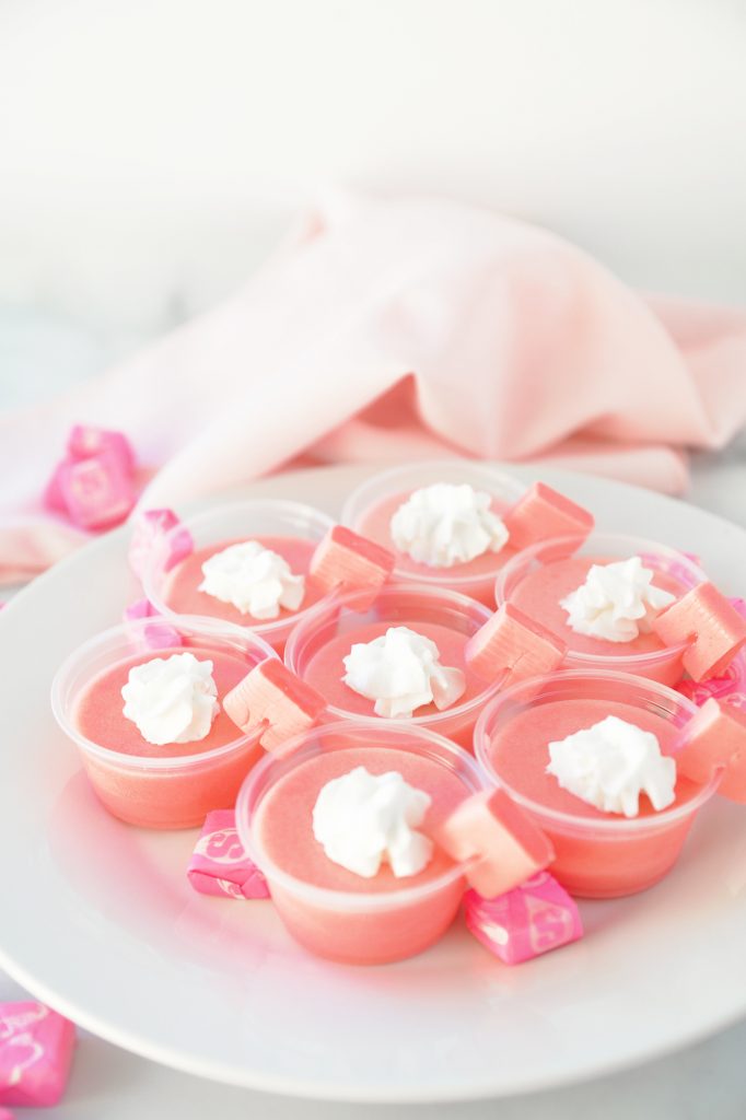 pink starburst jello shots on plate with pink starbursts for garnish