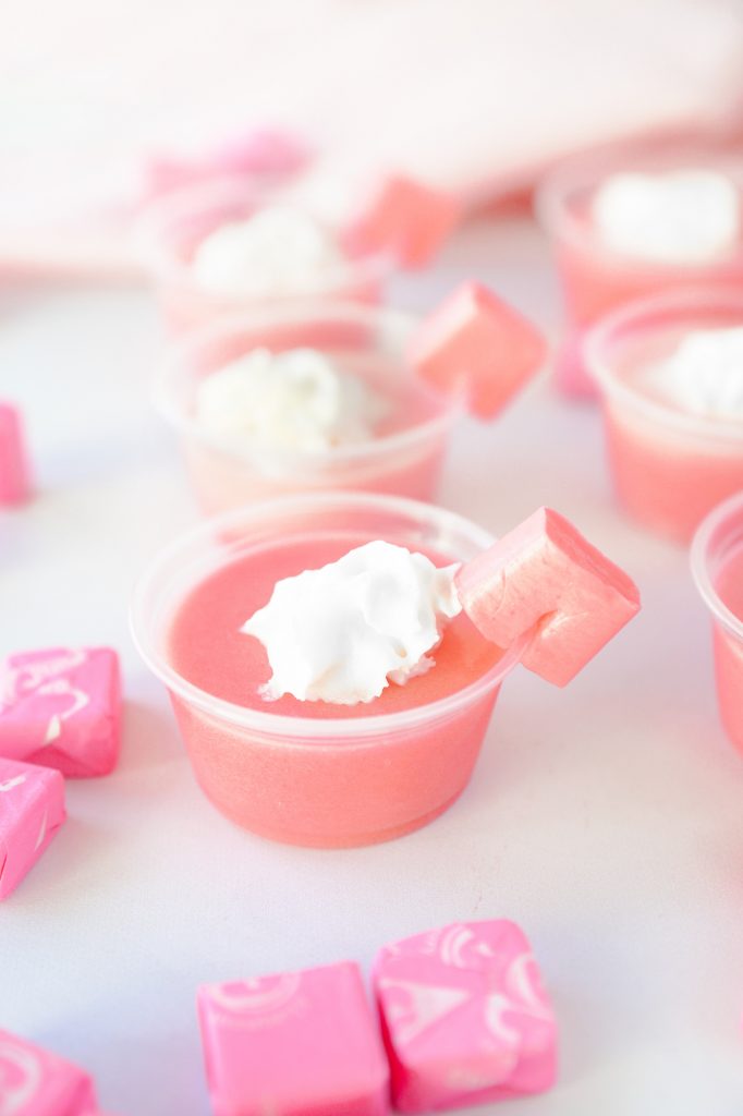 single pink jello shot with Starbursts