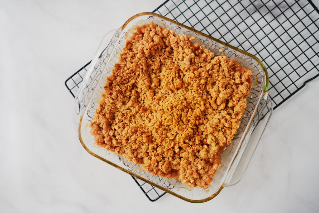 brown and well cooked vegan apple crumble on cooling rack