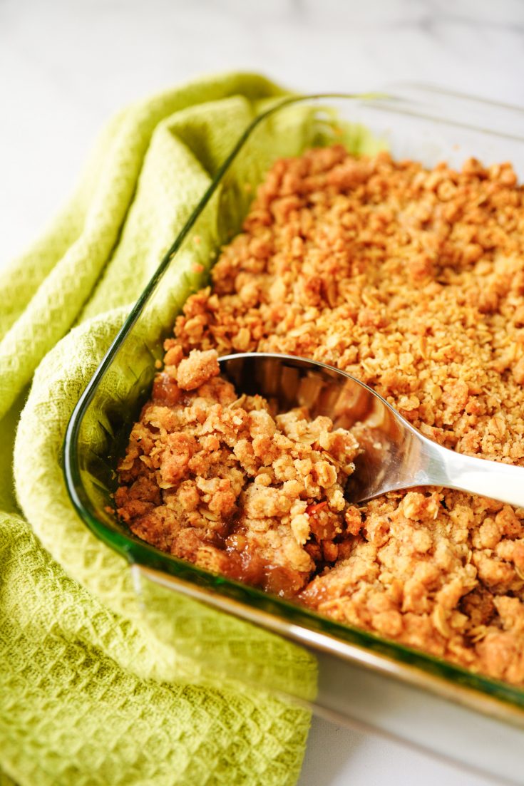 vegan apple crisp being scooped out