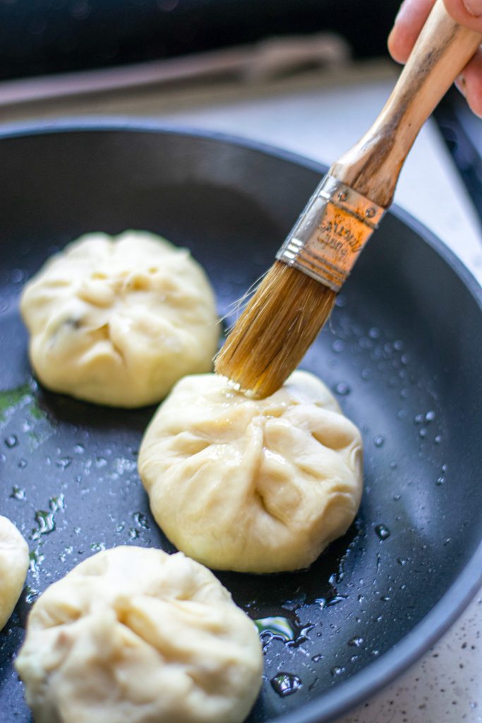 brushing vegan bao bun with oil