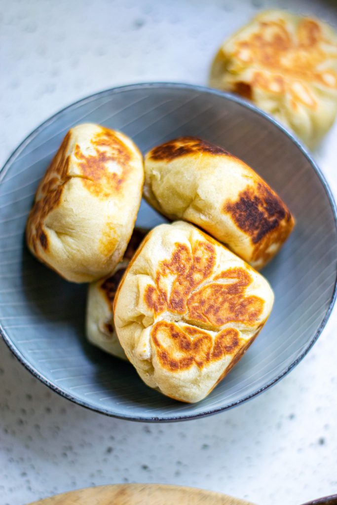 pan fried vegan bao buns in bowl