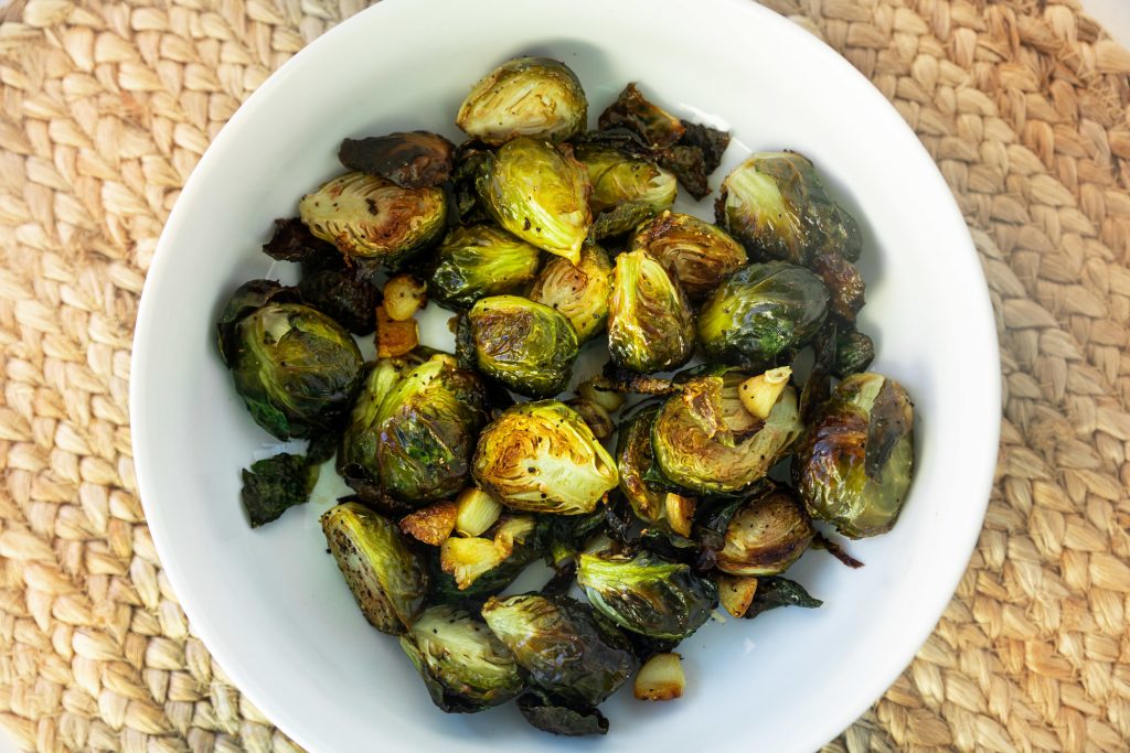 bowl of vegan brussels sprouts on brown placemat