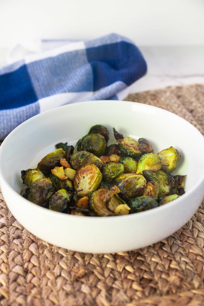 roasted vegan brussels sprouts with garlic in serving bowl