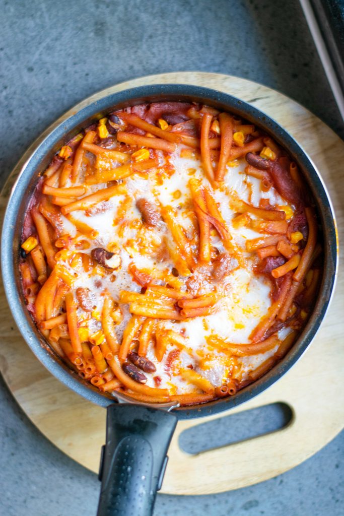 Straight down view of pot of orange and white vegan chili mac which is the perfect vegan fall recipe.