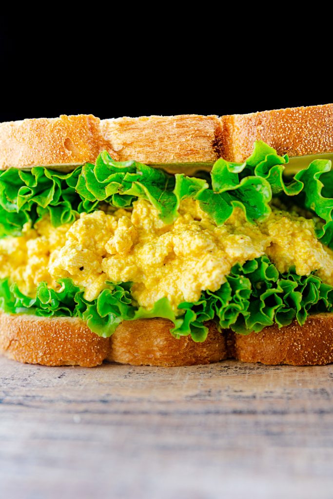 vegan egg salad sandwich on brown counter