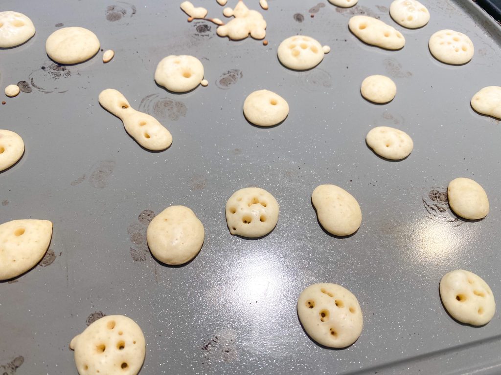 close up photo of vegan pancake cereal cooking on griddle