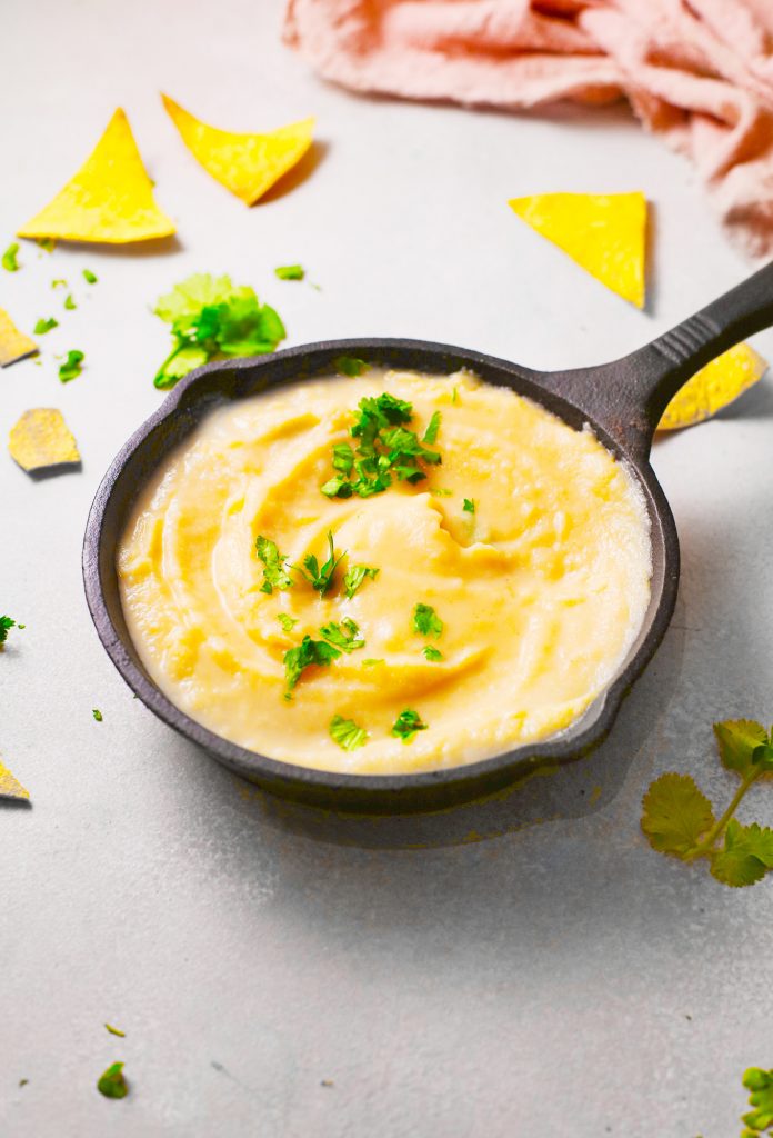 side view of queso that is vegan in cast iron dish