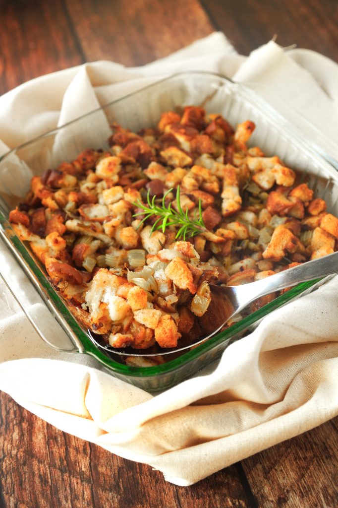 vegan stuffing in a baking dish on wood background