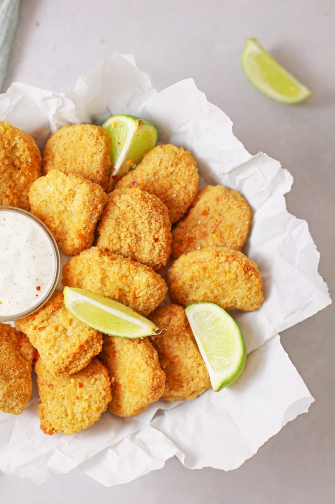 crispy baked tofu with limes on a plate