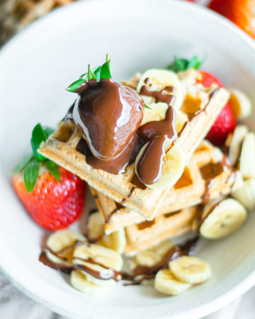 chocolate covered strawberry on top of waffle that is vegan