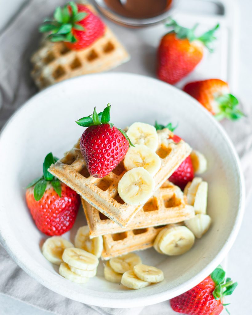 far away view of vegan waffles in white bowl