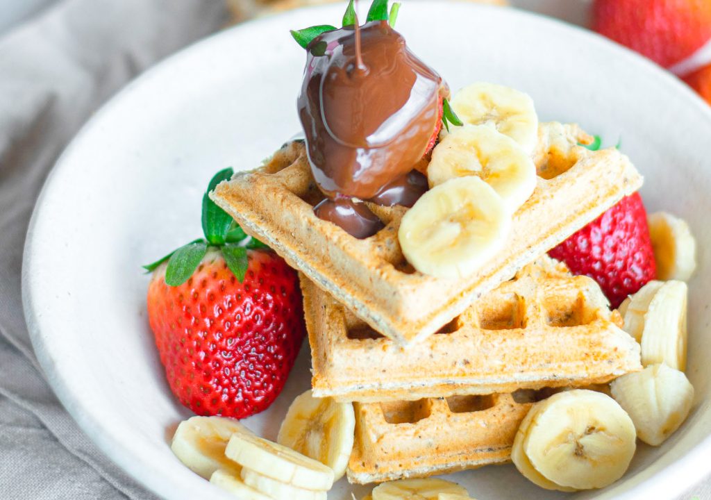 vegan waffles in bowl with fresh fruit