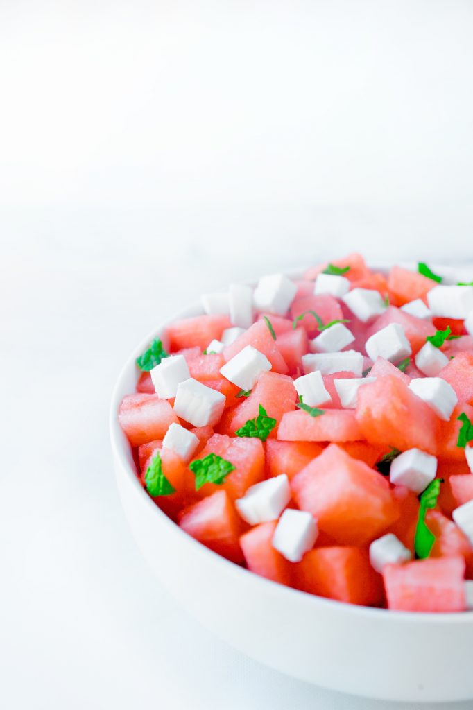 side of bowl holding vegan watermelon salad