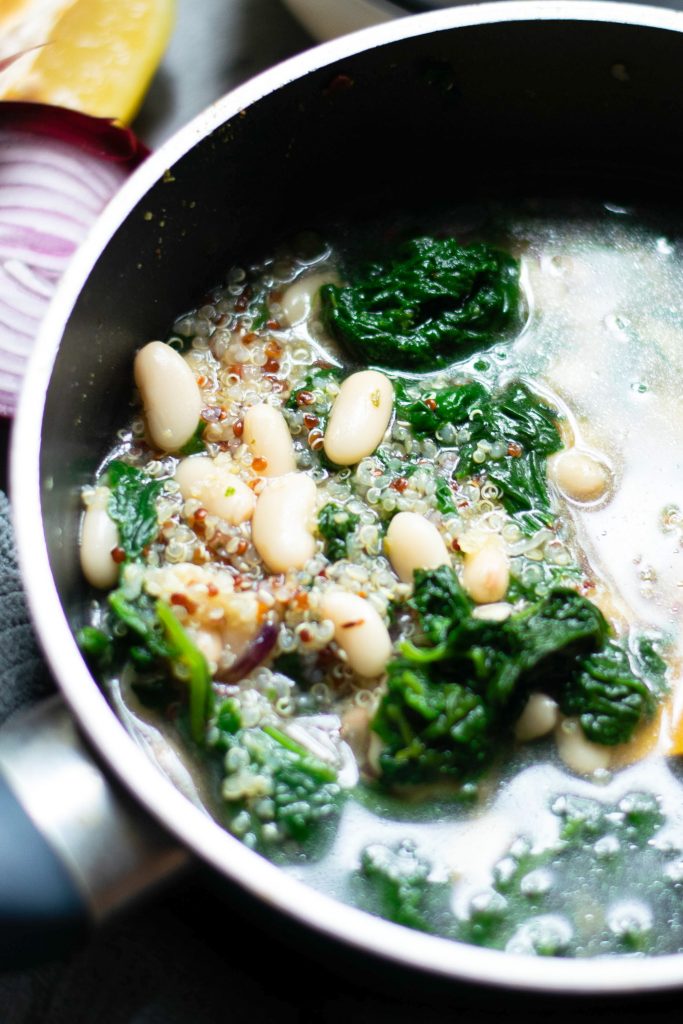 close up of vegan white bean soup cooking in soup pot