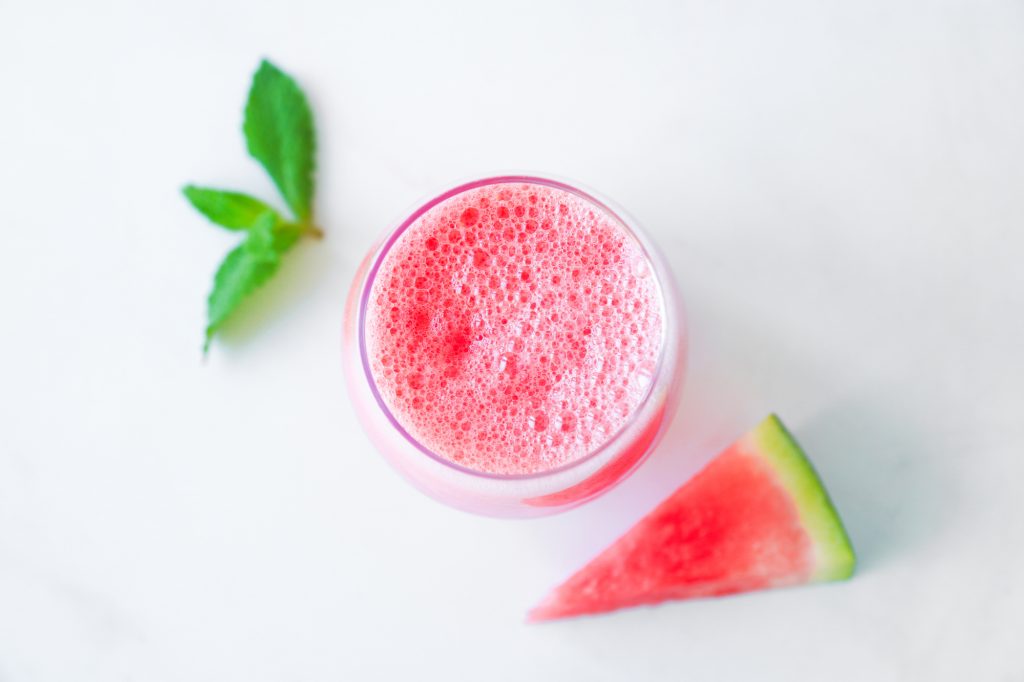 watermelon banana smoothie in glass with mint