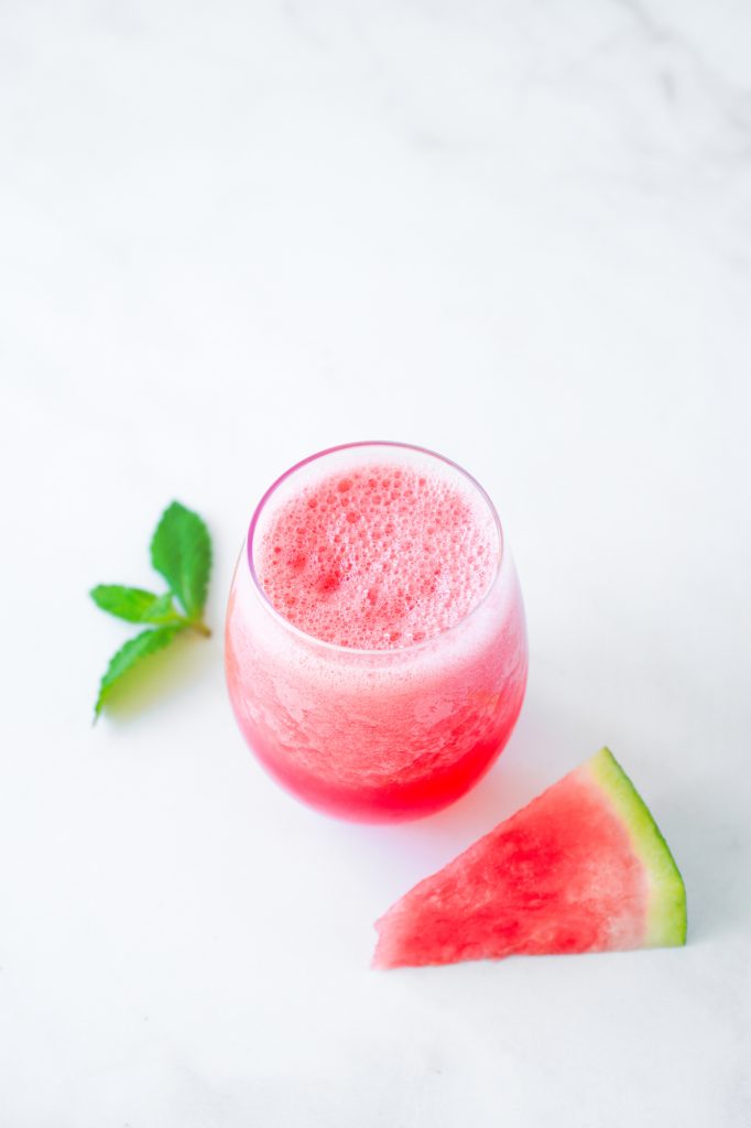 top down view of smoothie in glass with watermelon