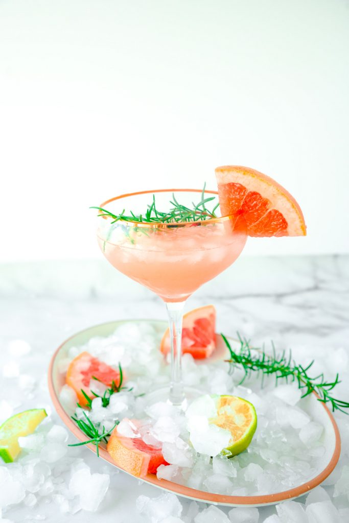 grapefruit cocktail with crushed ice on serving tray
