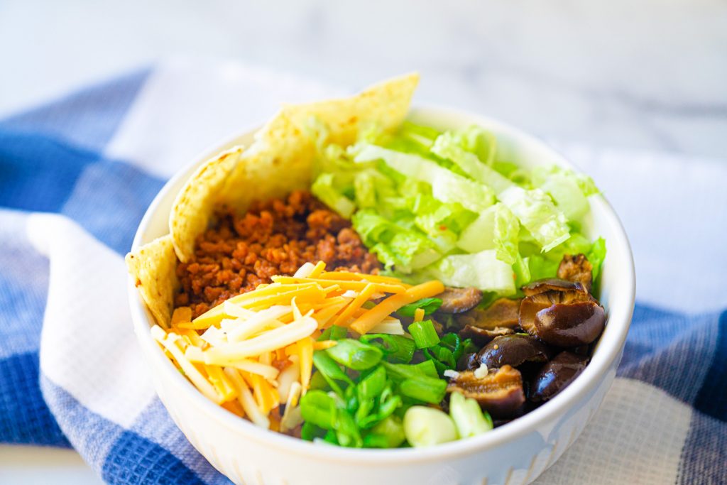 close up photo of a vegan burrito bowl recipe with blue checked towel