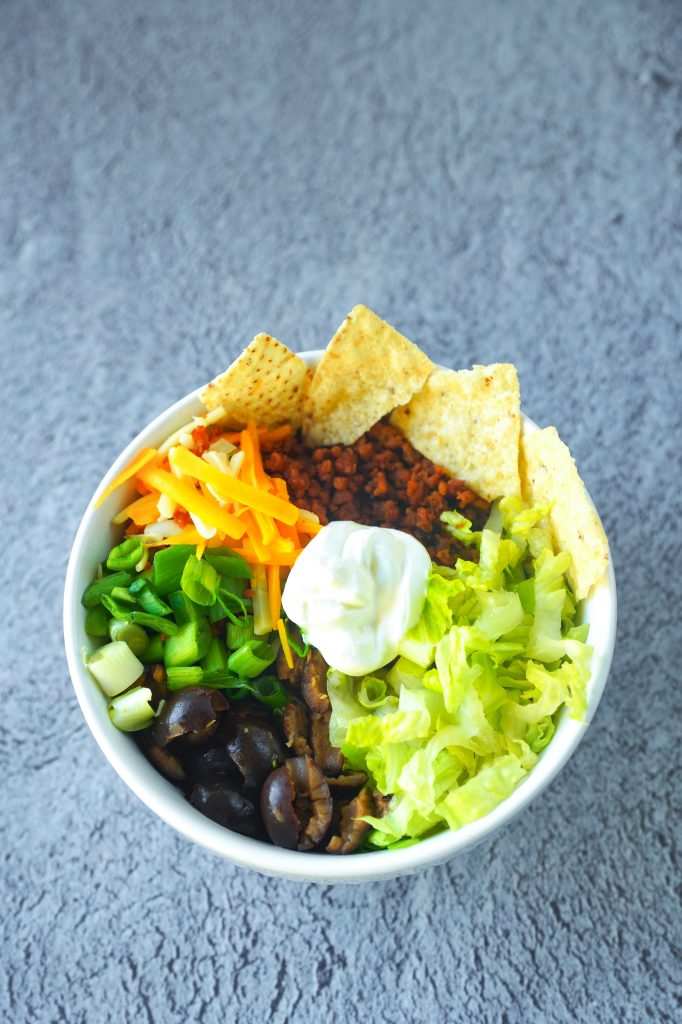 ingredients for a vegan burrito bowl with tortilla chips