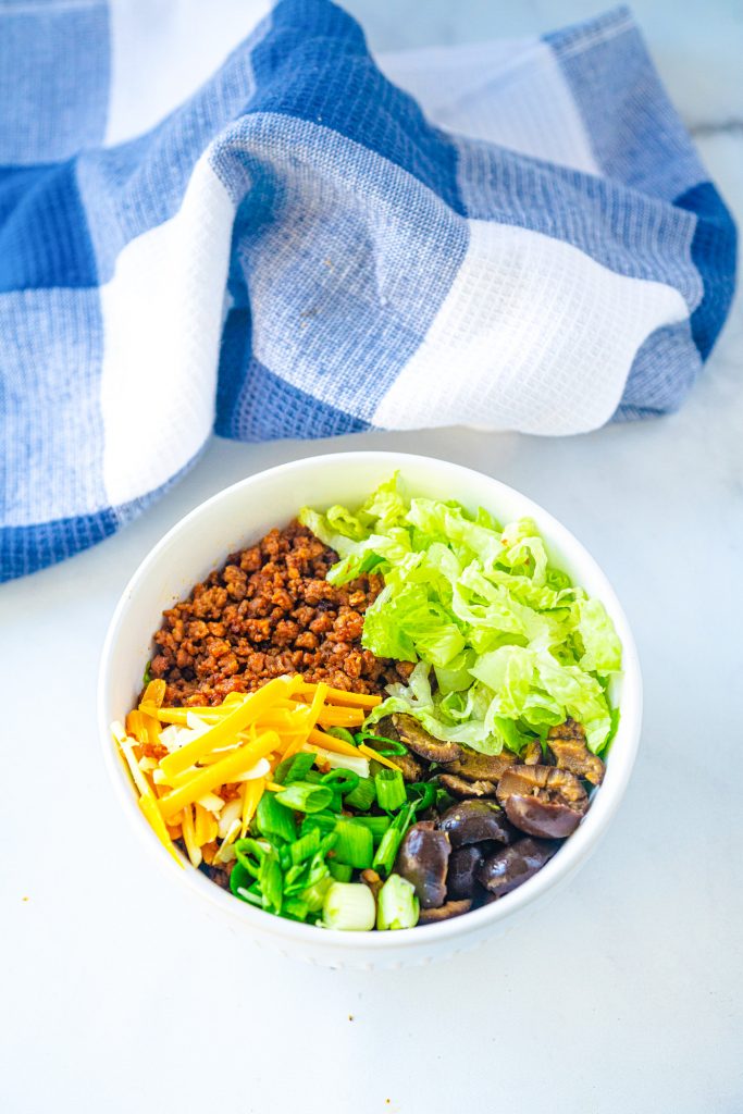 vegan burrito bowl topped with veggies