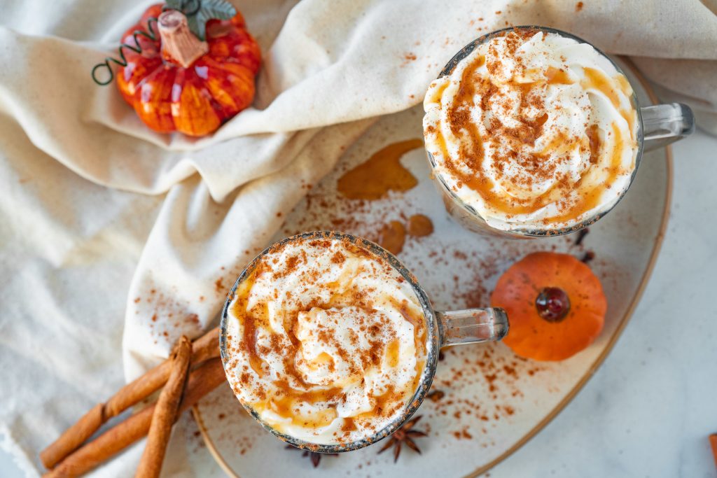 two lattes drizzled with vegan caramel sauce