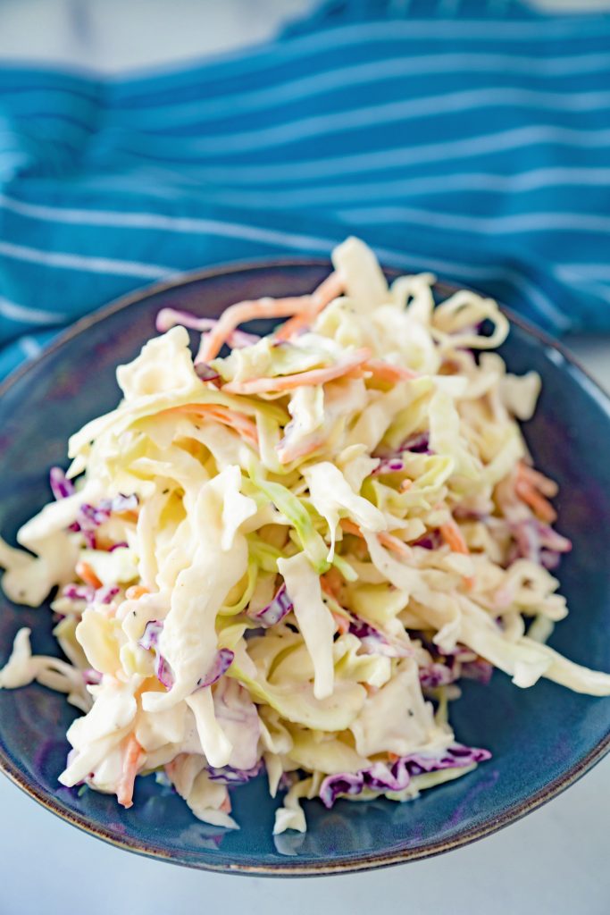 bowl of vegan coleslaw on blue towel