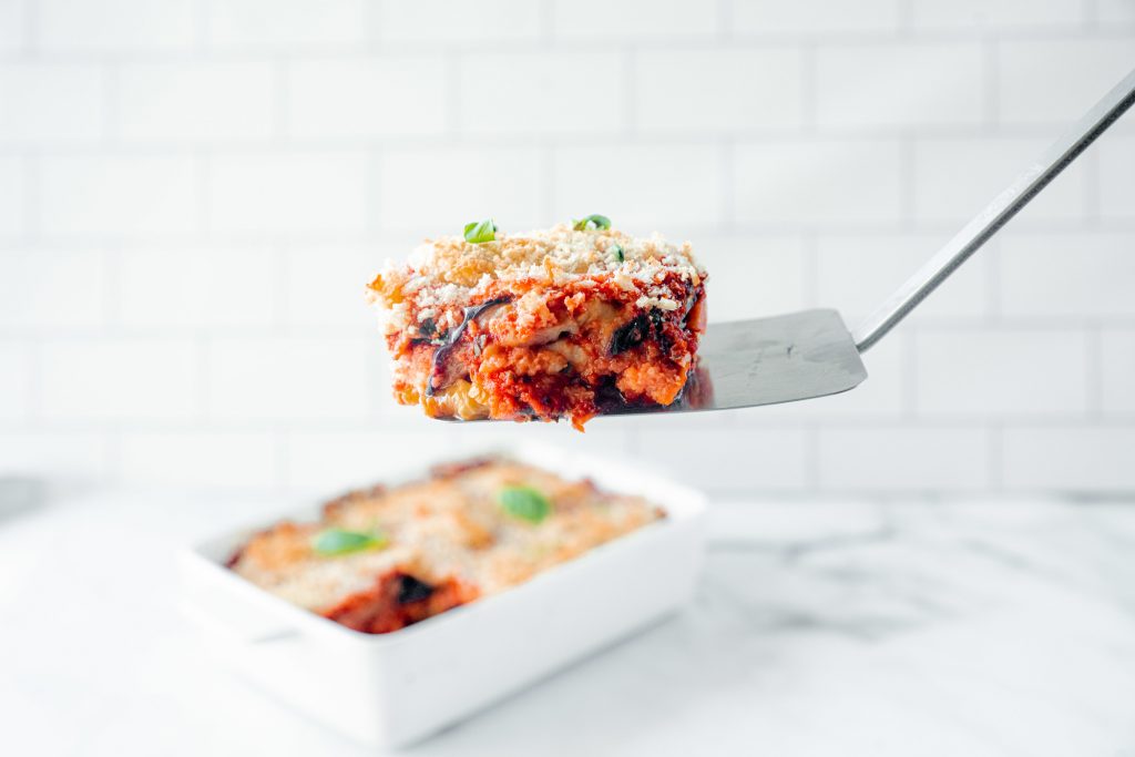 spatula picking up a slice of vegan eggplant parmesan