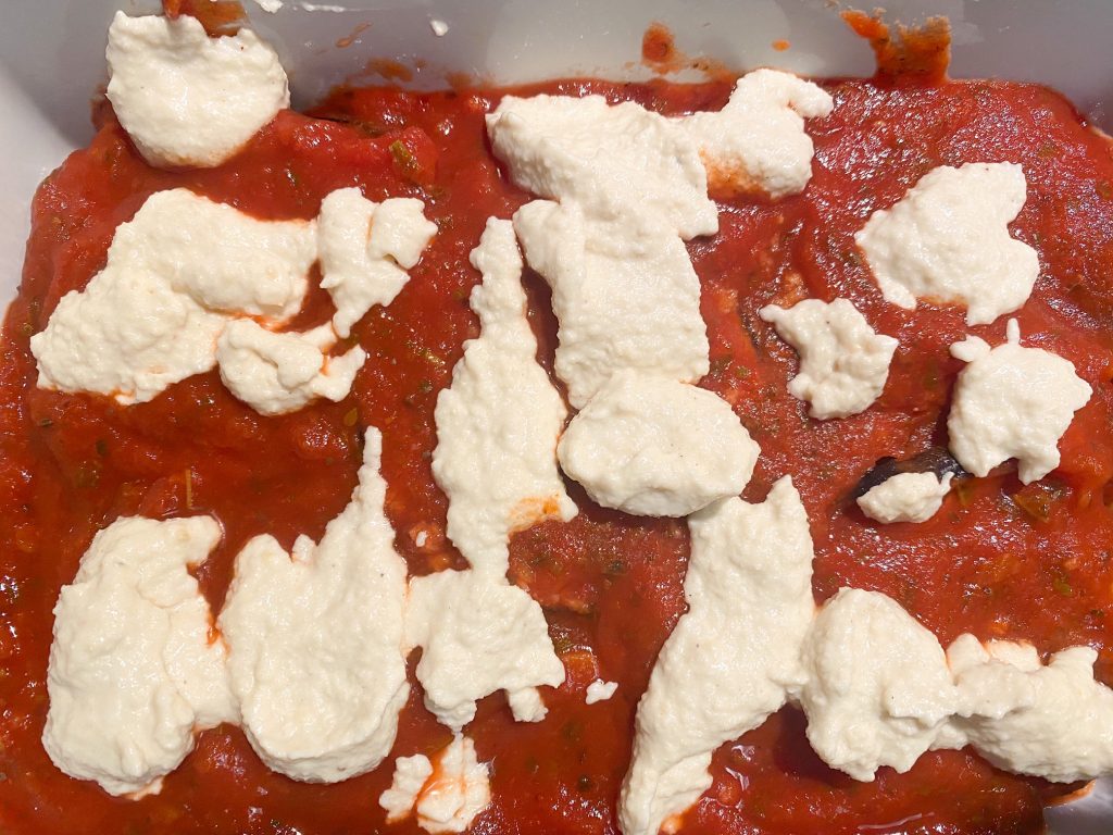 cashew cheese on top of jarred tomato sauce