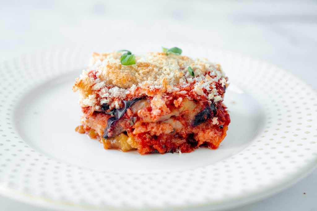 slice of vegan eggplant parmesan topped with basil