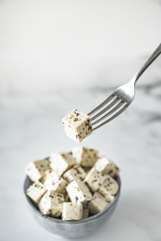 fork holding a slice of tofu feta