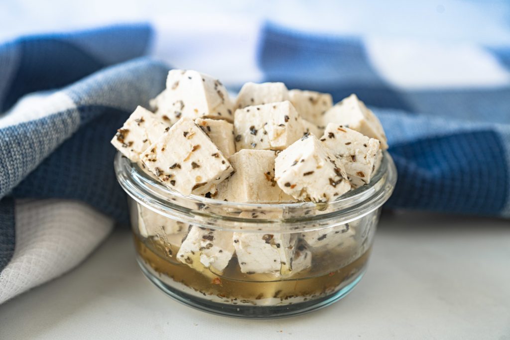 vegan feta in marinade of oil with spices
