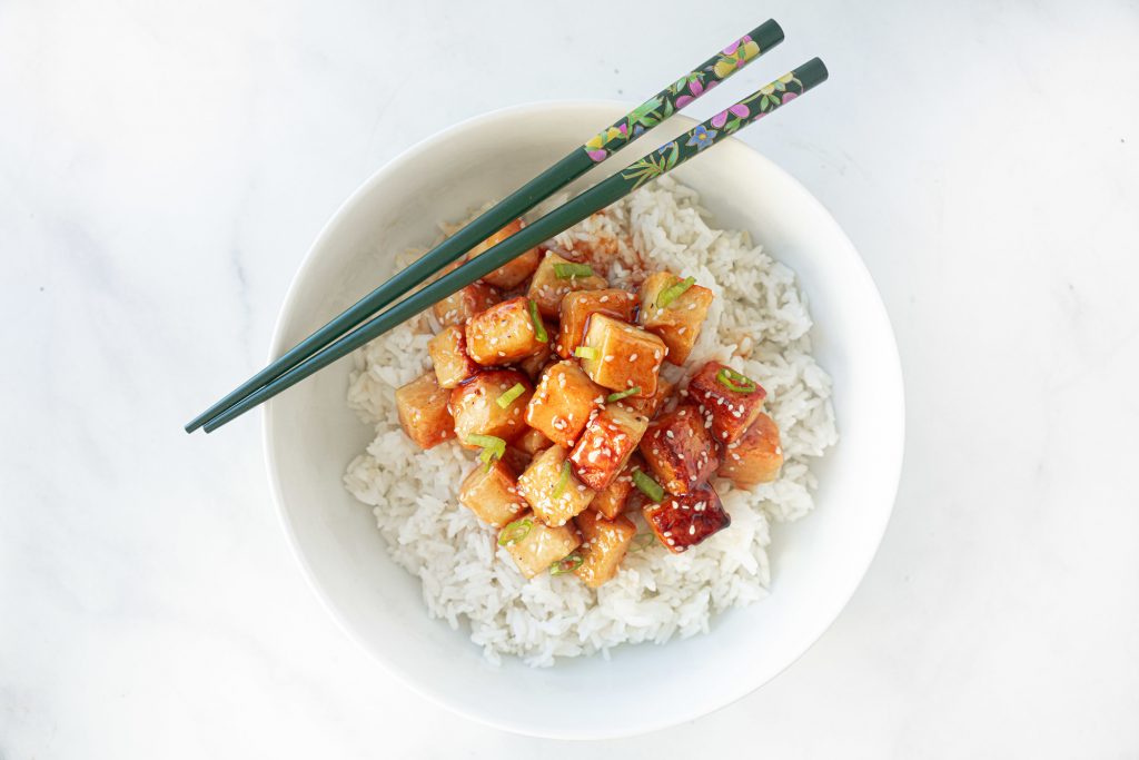 vegan orange chicken from above with chopsticks