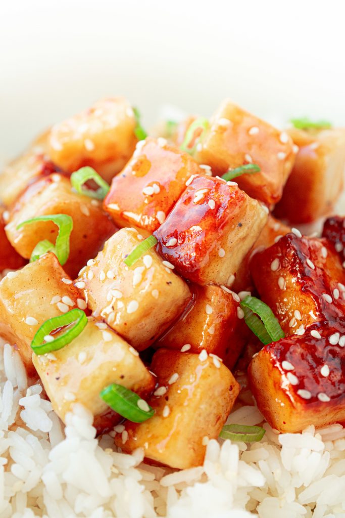 close up of vegan orange chicken in bowl