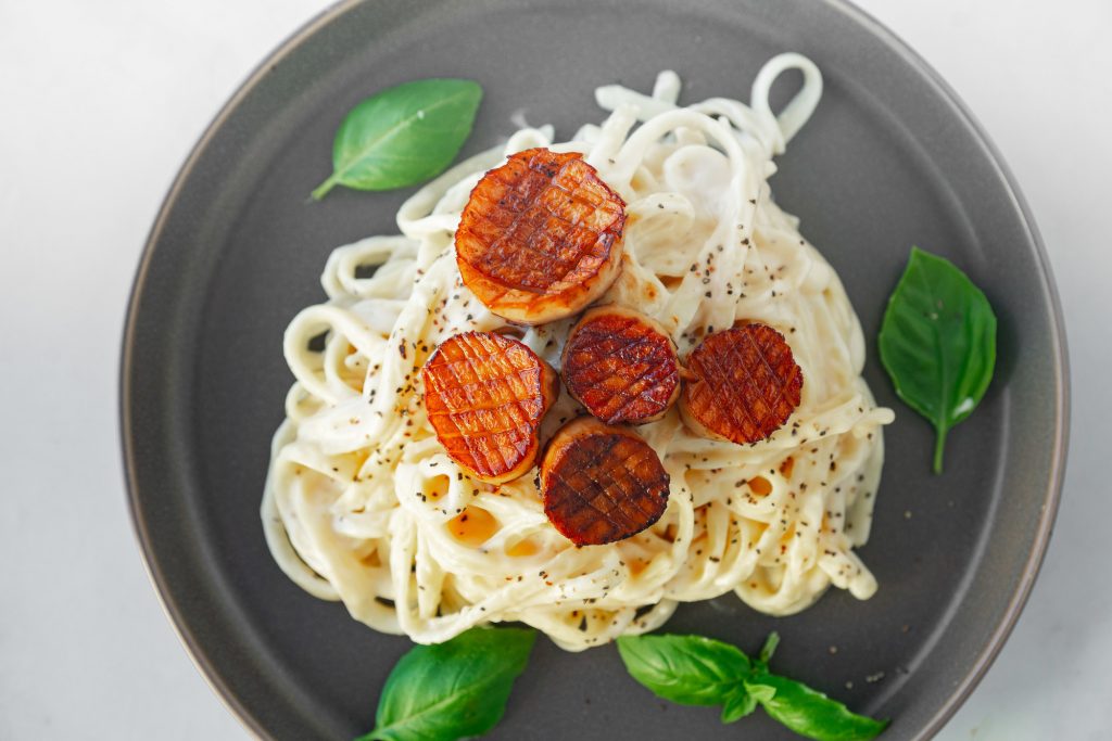 above image of vegan scallops on alfredo pasta