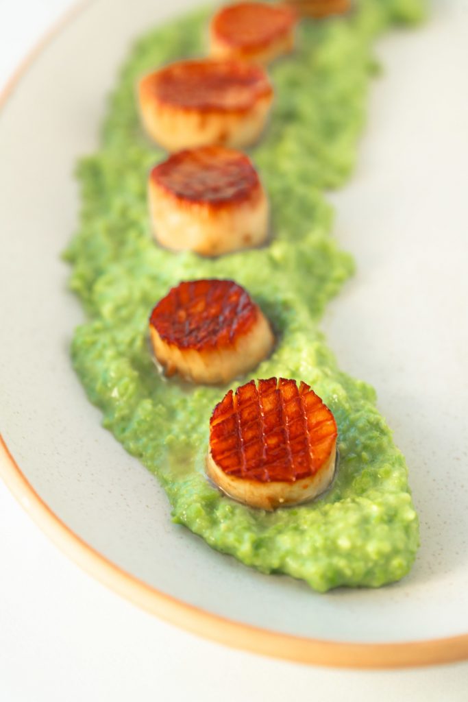 close up of vegan scallops on truffle pea puree