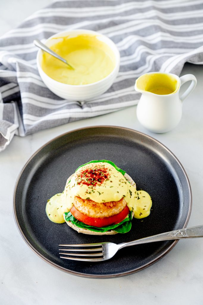 fork on a plate with vegan eggs benedict and sauce