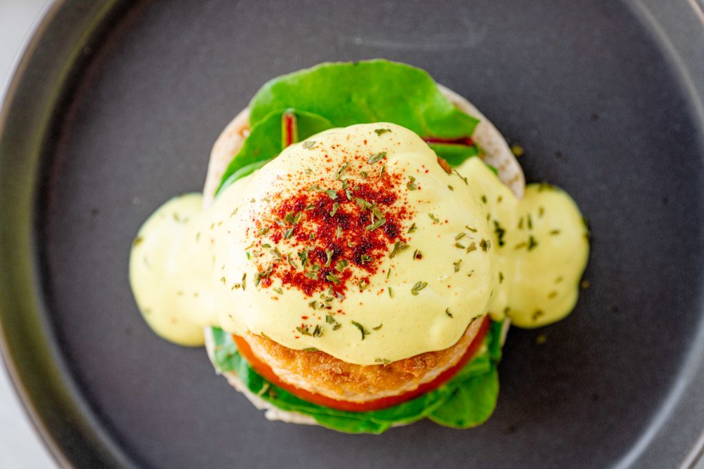 top view of a vegan eggs benedict with hollandaise sauce
