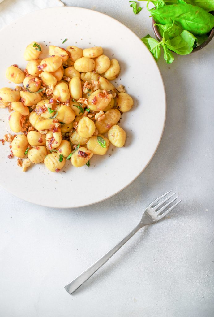 vegan gnocchi on plate with basil