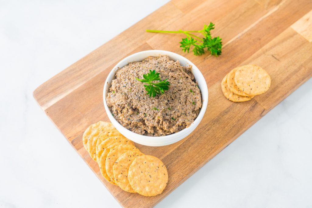 vegan mushroom pate in a bowl on a cutting board