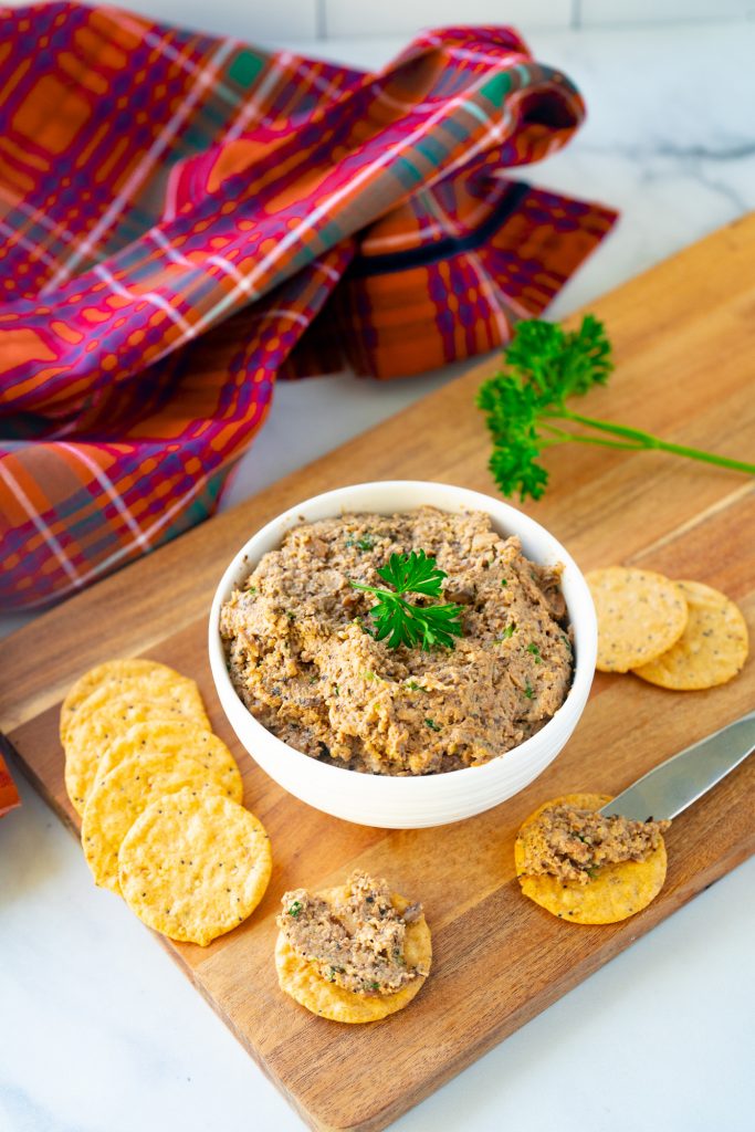 plaid towel with a bowl of vegan pate and crackers