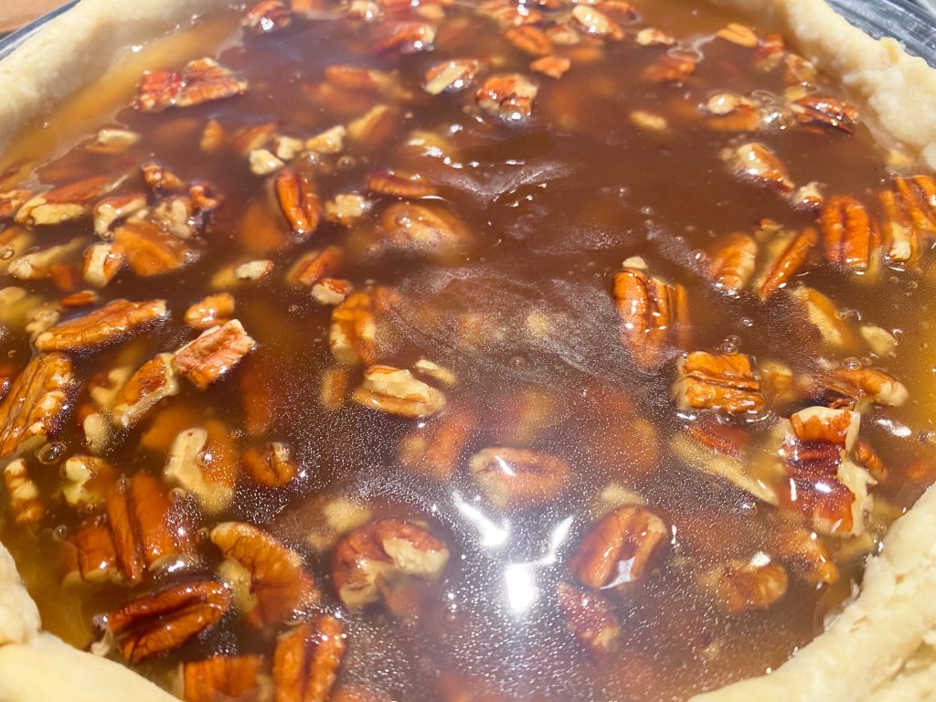 brown pecan pie filling without corn syrup setting in a pan 