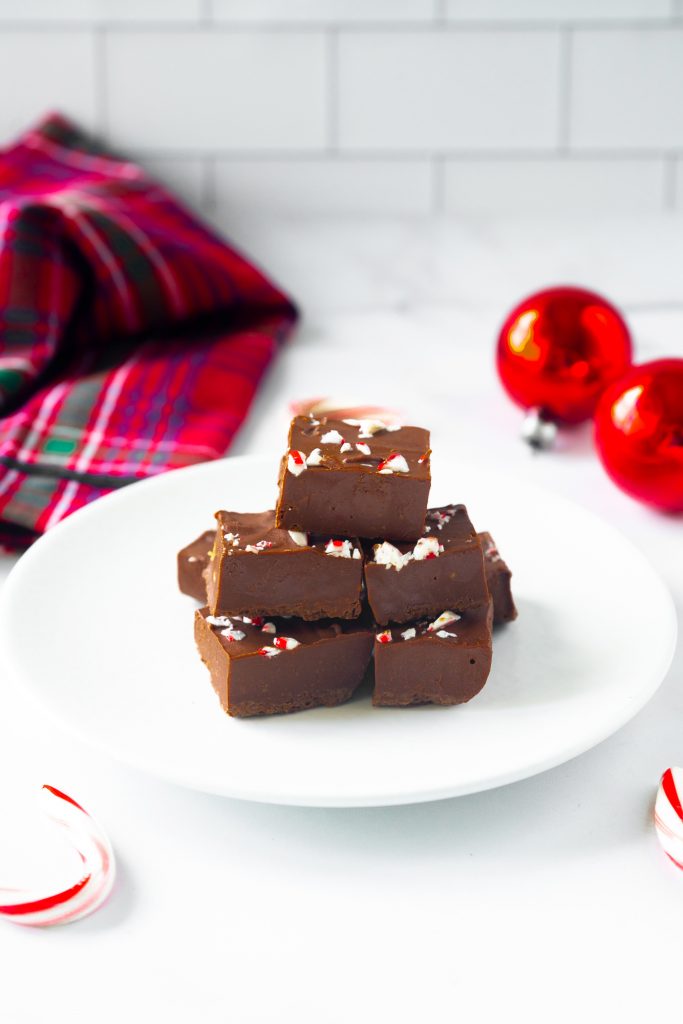 vegan peppermint fudge on serving dish with crushed candy canes