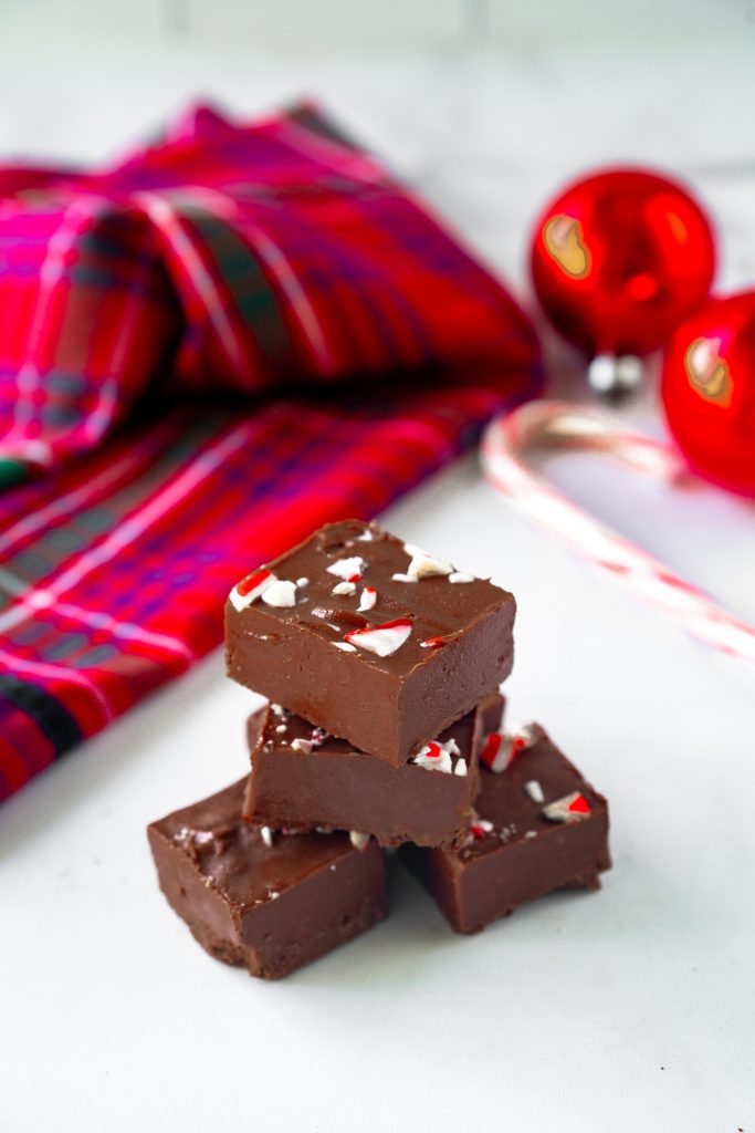 vegan peppermint fudge on counter with candy cane in background