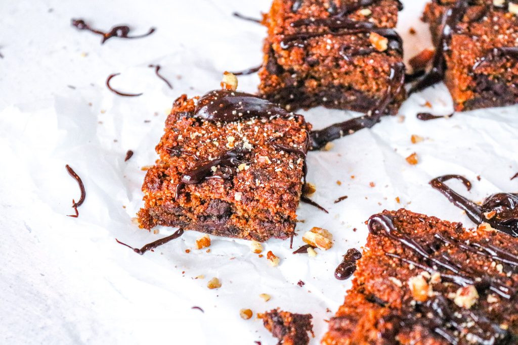 pumpkin brownies made vegan after baking with fudgy chocolate sauce poured over