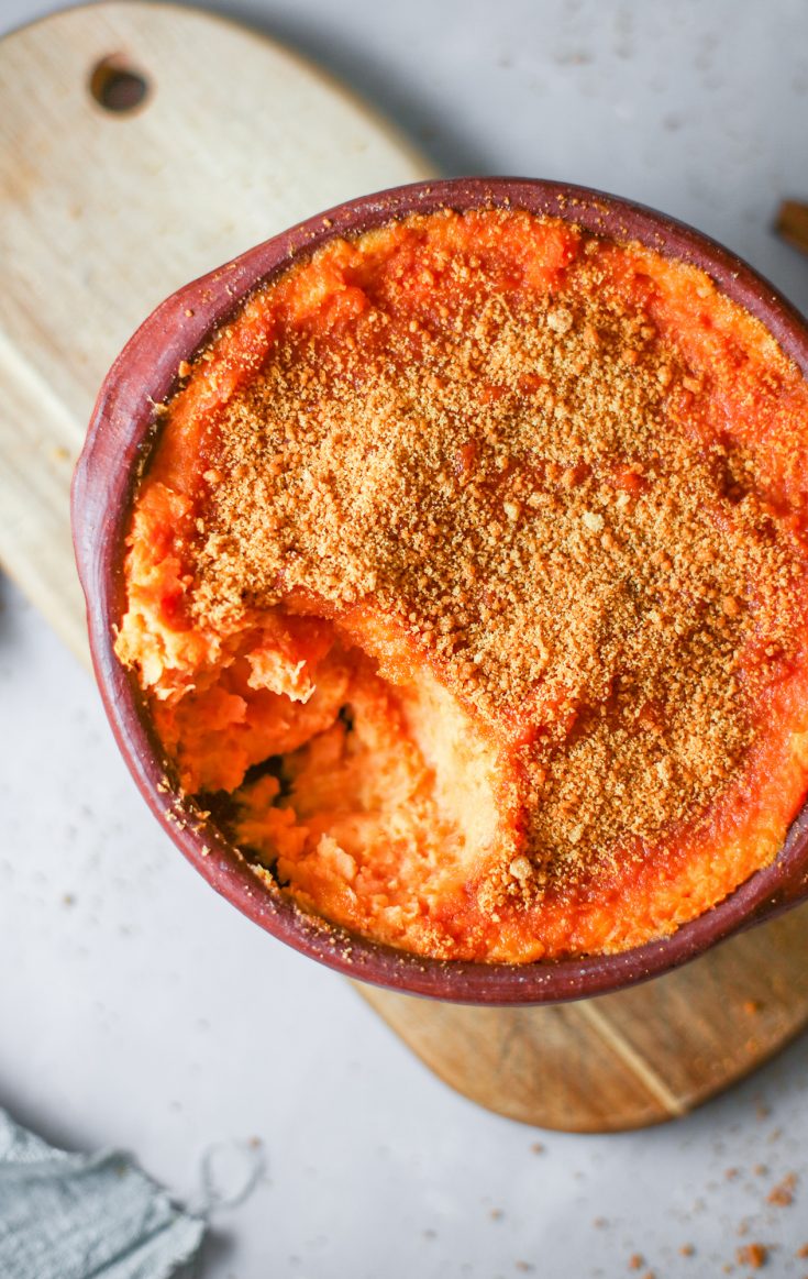 vegan sweet potato casserole with spoon taking a piece out