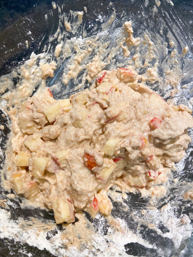 batter for making vegan apple fritters barely combined in mixing bowl
