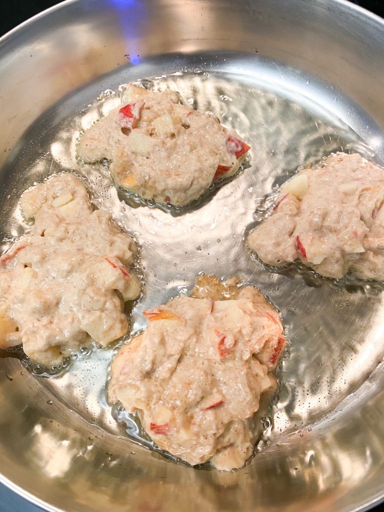 Uncooked apple fritters in a bowl.