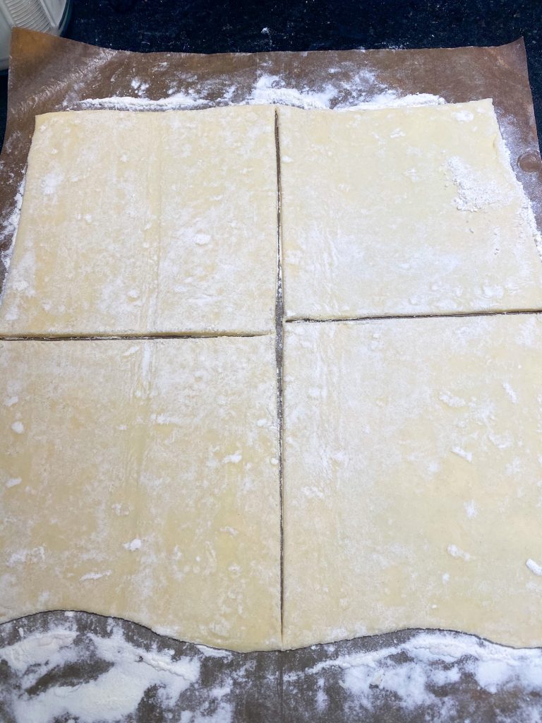 tan color puff pastry rolled out and cut into four squares