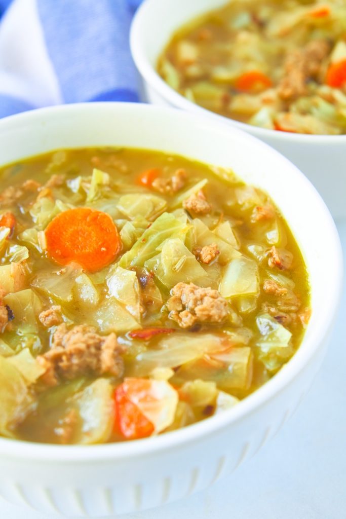 Close up of soup with vegan beef, carrots, and cabbage.